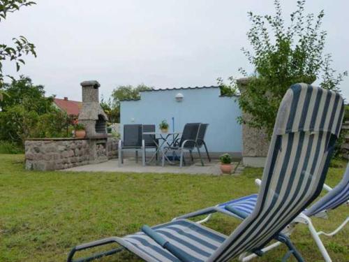 a couple of lawn chairs sitting in a yard at Ferienunterkuenfte Feldmann in Korswandt