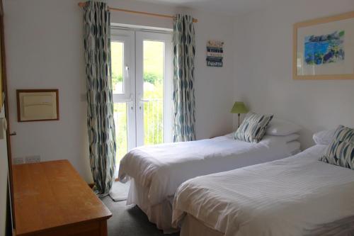 a hotel room with two beds and a window at Seascape - Mount Brioni in Downderry