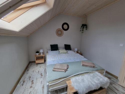 a bedroom with a large bed in a attic at Apartament Domek w Górach Gorce Pieniny in Tylmanowa