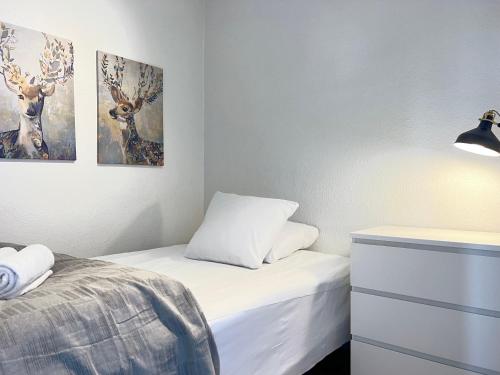 a bedroom with a bed and two paintings on the wall at Two Bedroom Apartment In Rdovre, Trnvej 37b, in Rødovre