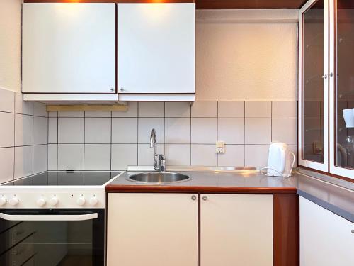 a kitchen with white cabinets and a sink at Two Bedroom Apartment In Rdovre, Trnvej 37b, in Rødovre