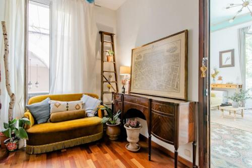 a living room with a chair and a fireplace at Habitación en La Rambla in Girona