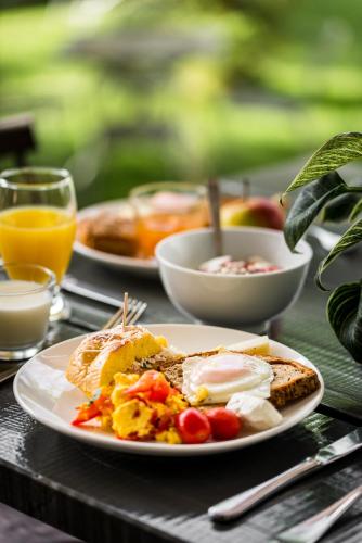 a table with two plates of breakfast food on it at Gefiri Plakas Hotel, Tzoumerka in Plaka