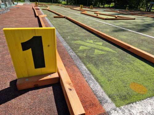 a row of wooden benches with a number on them at Nykščio Namai & SPA in Anykščiai