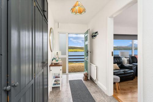 a hallway with a living room with a view of the water at Cottage 439 - Clifden in Clifden