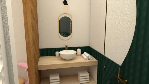 a miniature bathroom with a sink and a mirror at Heritage Ecolodge in Le Tampon