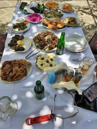 a table with many plates of food on it at Villa Goliku in Peshtan