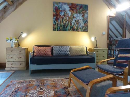 a living room with a couch and a painting on the wall at Ty Cefn Tregib B&B in Llandeilo