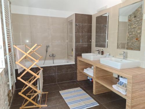 a bathroom with two sinks and a large mirror at Villa stone house in Ugljan