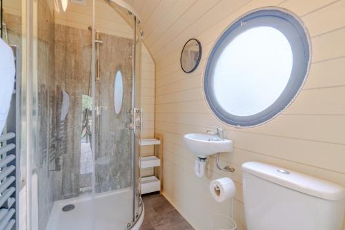a bathroom with a shower and a toilet and a sink at Laburnum Farm Estate in Alderton