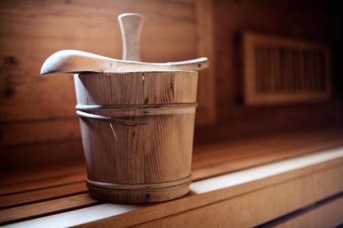 a wooden cup with a spoon sitting on a table at Hotel Stubaierhof in Neustift im Stubaital