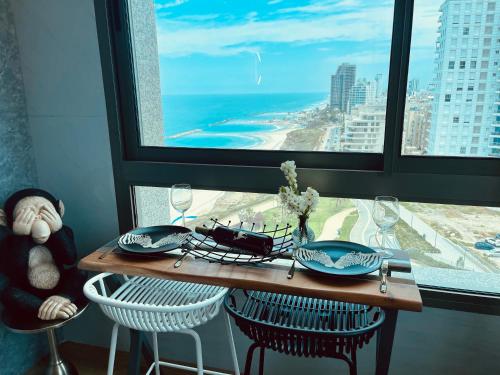 a table in a room with a view of the ocean at C Tower Premium Apartments, Panoramic Sea View in Netanya