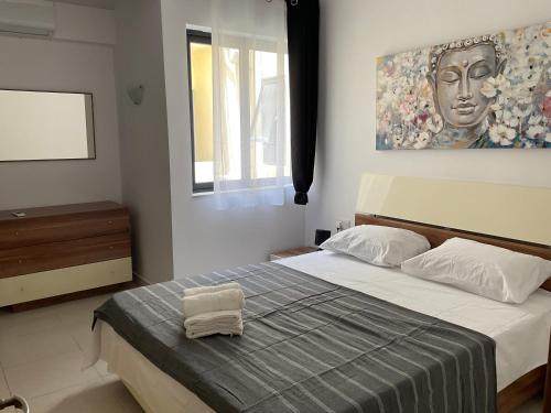 Schlafzimmer mit einem Bett mit Wandgemälde in der Unterkunft Privilege suits Swatar in Birkirkara