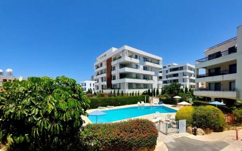 a view of a apartment complex with a swimming pool at 1st Floor 1st Class Pool View Apt. in Paphos