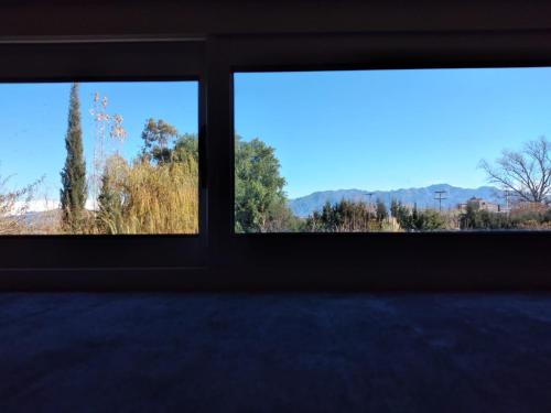 two windows in a room with a view of trees at PATO BLANCO in Ciudad Lujan de Cuyo