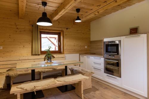 a kitchen with a table and a refrigerator at Chata Planina in Michalová