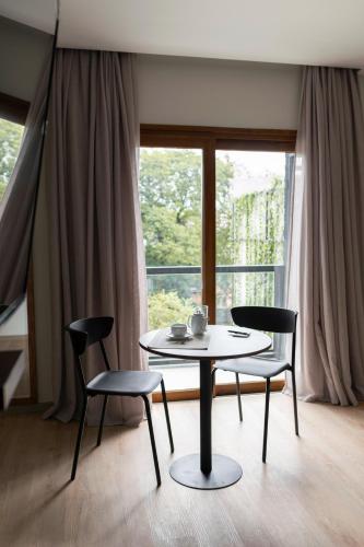 a table and chairs in a room with a window at Five Hotel & Residences in Asuncion