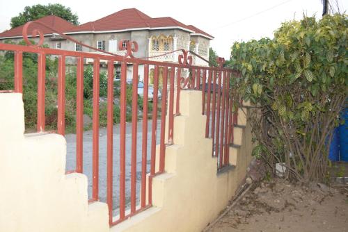 a wrought iron fence in front of a house at Cozy Oasis Studio in Portmore