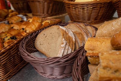 a group of baskets of bread and pastries on a table at Apparthotel Privilodges Lyon Lumière in Lyon