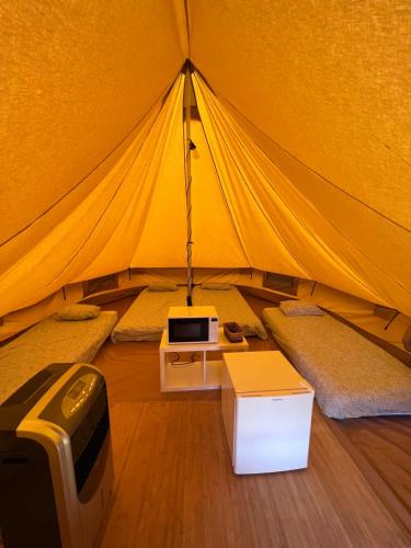 a tent with a bed and a tv in it at Camping & Glamping Muiñeira in O Grove