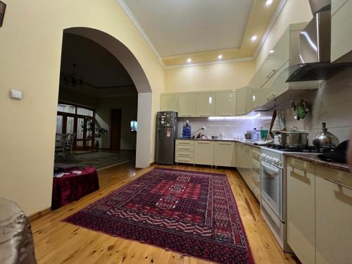 a large kitchen with a rug on the floor at Brown Hill in Samarkand