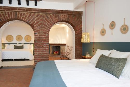 a bedroom with a bed and a brick fireplace at AmazINN Stay CDMX Coyoacan in Mexico City