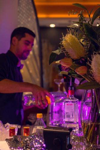 a man standing behind a table with a vase of flowers at Aldiana Club Salzkammergut und GrimmingTherme in Bad Mitterndorf