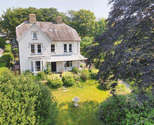 an aerial view of a white house with a yard at House of Brohedyn in Newcastle Emlyn