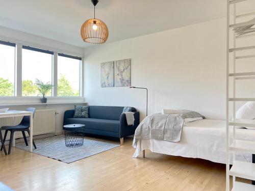 a bedroom with a bed and a couch and a table at Studio Apartment In Glostrup, Hovedvejen 70, 3 in Glostrup