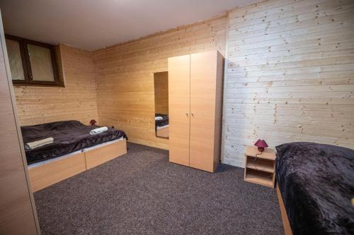 a room with two beds and a closet in it at Panelcz in Uherčice
