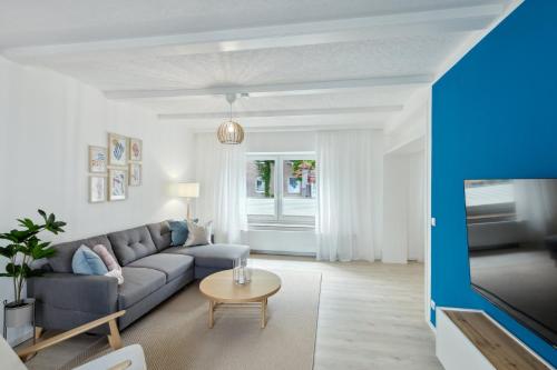 a living room with a couch and a table at AT WEINMEISTER - Großzügigkeit & Ruhe in Gütersloh