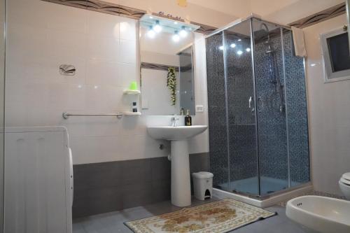 ein Bad mit einer Dusche, einem Waschbecken und einem WC in der Unterkunft La casa del nonno in Borgagne
