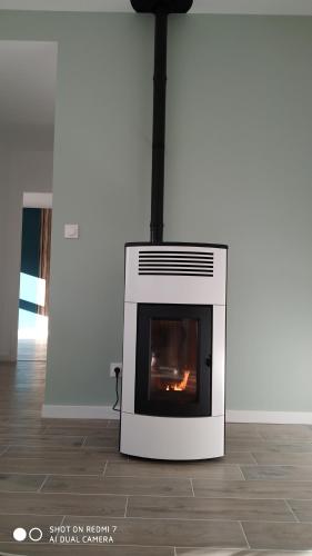 a oven sitting on the floor with a fire in it at Appartement zen in Saint-Nicolas-de-la-Grave