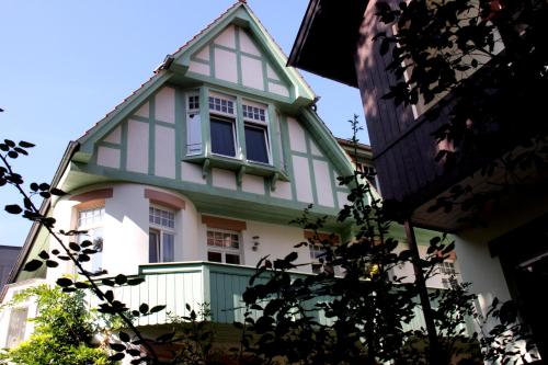 een groen en wit huis met een raam bij Hotel Heidelberg Astoria in Heidelberg