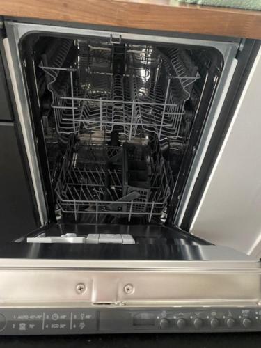 an open oven with a dish rack in it at "Le petit bonlieu" au centre ville et à 300 m du lac in Annecy