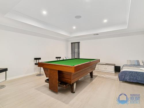 a living room with a pool table in it at Water Lovers Haven in Mandurah in Mandurah