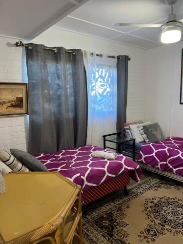 a room with two beds and a window at XYL Holiday Inn in Caloundra