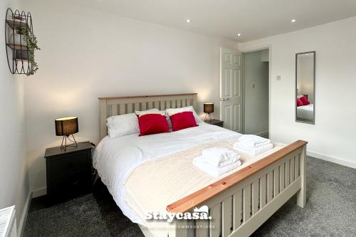 a bedroom with a large bed with red pillows at Stunning 3bdr 2ba House With Free Street Parkin in Birmingham