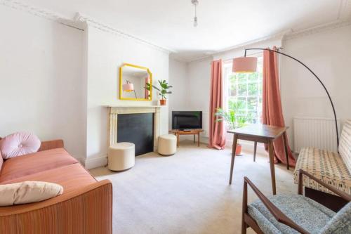 a living room with a couch and a fireplace at Charming & Central 2BD Flat - Islington in London