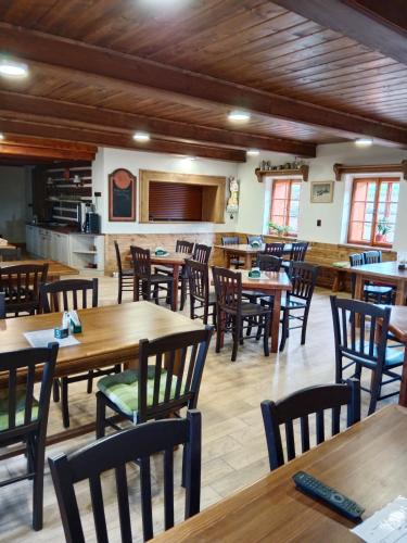 a dining room with wooden tables and chairs at Horská bouda Krakonoš in Pec pod Sněžkou