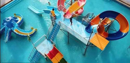 an image of a water park with a water slide at الساحل الشمالي. قريه جراند هيلز الكيلو60 in Dawwār ‘Abd Allāh