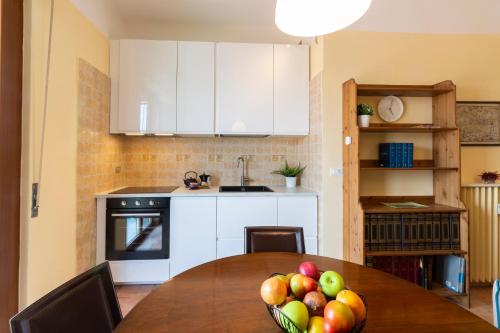 a kitchen with a table with a bowl of fruit on it at Gonin San Cristoforo in Milan