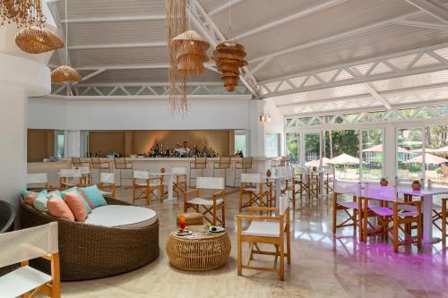 a lobby with tables and chairs and a bar at Martı Myra - Ultra All Inclusive in Tekirova