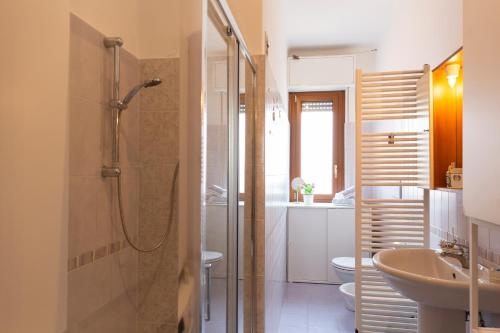 a bathroom with a shower and a sink and a toilet at Gonin San Cristoforo in Milan