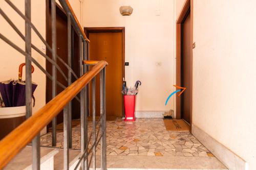 a hallway with a red trash can with umbrellas in it at Gonin San Cristoforo in Milan