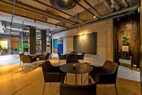 a restaurant with tables and chairs in a room at Ingu Stay in Yangyang