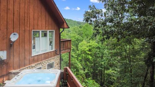 a hot tub on the side of a house at Lily's Lookout Lodge - Helen, GA in Helen