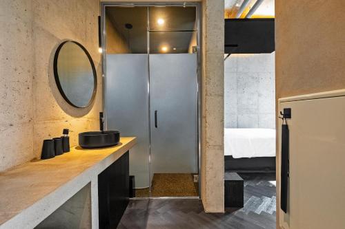 a bathroom with a sink and a mirror at Ingu Stay in Yangyang