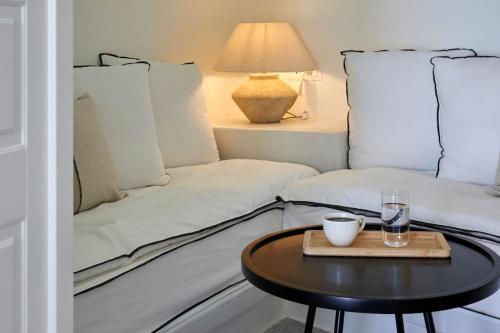 a living room with a couch and a table at Lerion Luxury Villas in Akrotiri