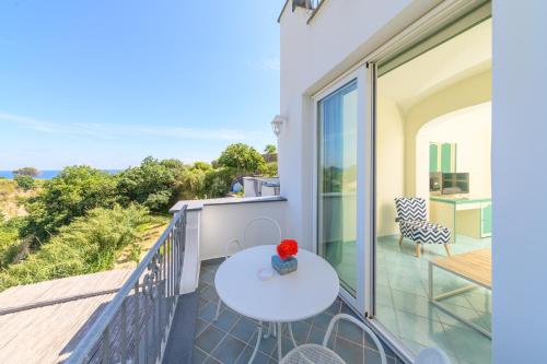 a balcony with a table and a view of the ocean at Sorgeto Garden in Ischia